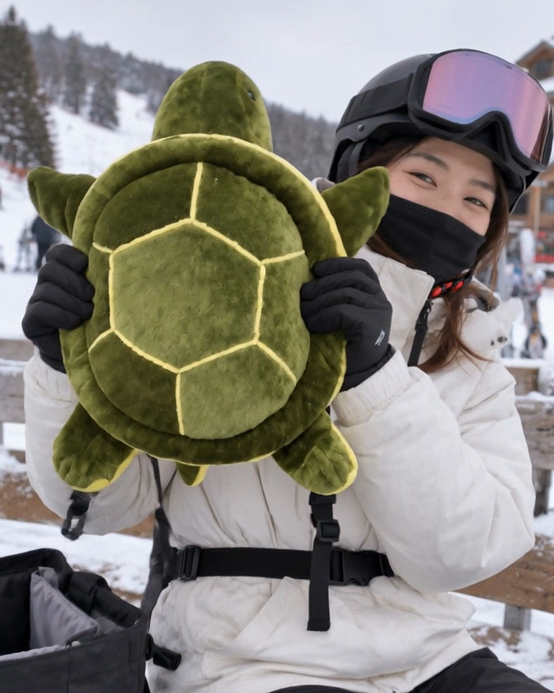 Bumplush Turtle Bum Protection held up on a ski-resort bench