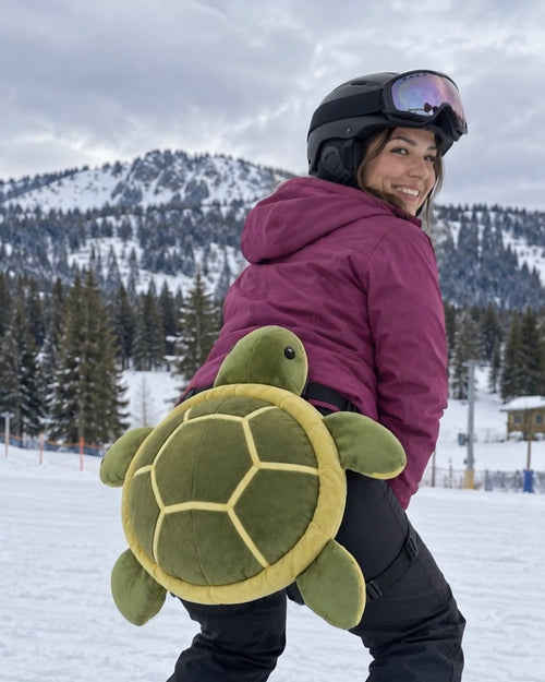 Snowboarder wearing the plush turtle bum pad on the slopes